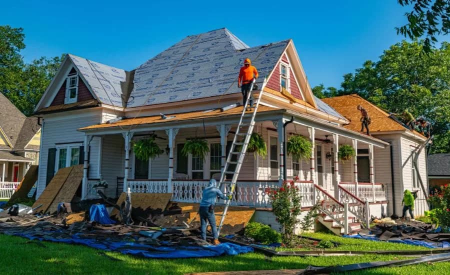 Roofing crew mid-replacement on a residential home